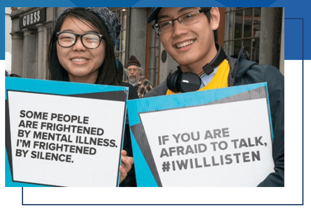 photo of two young people holding signs that say Some people are frightened by mental illness if you are afraid to talk, i will listen