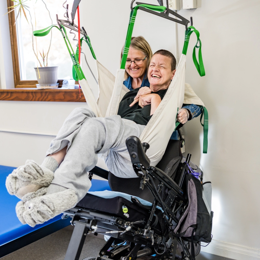 volunteer with individual with disabilities laughing