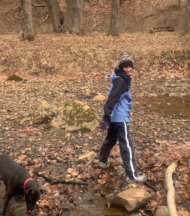 Dvora in woods with dog Tali